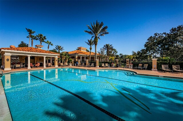 9933 Milano Dr, Trinity, FL 34655 - community pool featuring fence and a patio