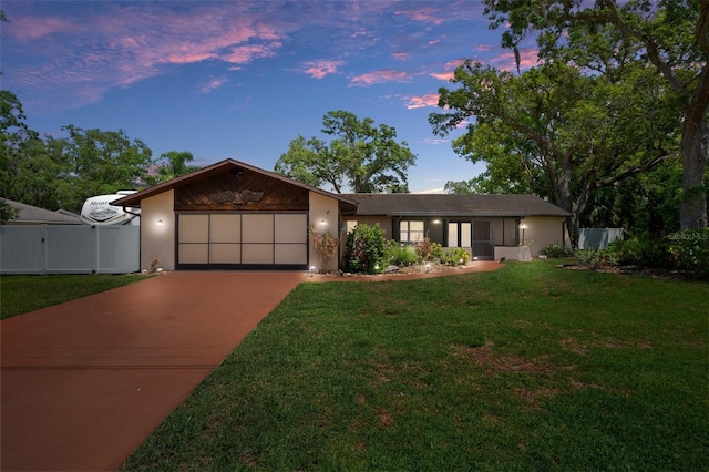 view of front of property featuring driveway, an attached garage, and stucco siding