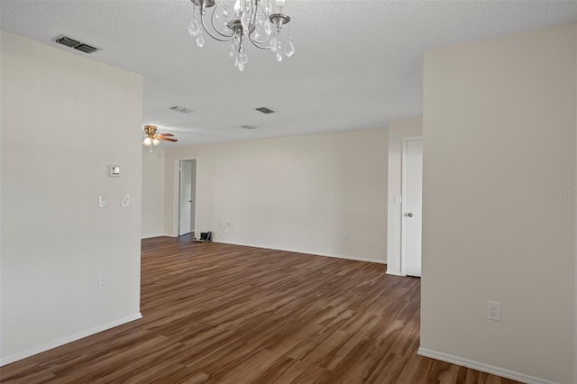 unfurnished room featuring wood finished floors, a chandelier, baseboards, a ceiling fan, and a textured ceiling