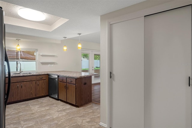 kitchen with dishwasher, a sink, light countertops, french doors, and pendant lighting