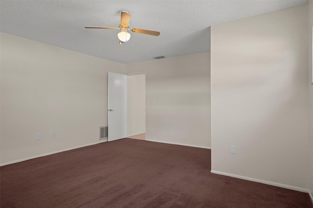 carpeted spare room featuring a ceiling fan, baseboards, and a textured ceiling