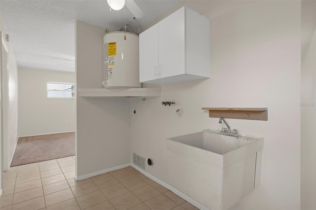laundry room featuring electric water heater, washer hookup, hookup for an electric dryer, cabinet space, and light tile patterned floors