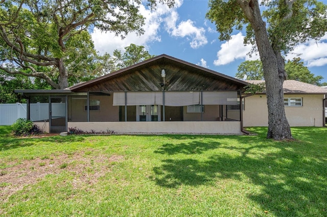 back of property with a sunroom
