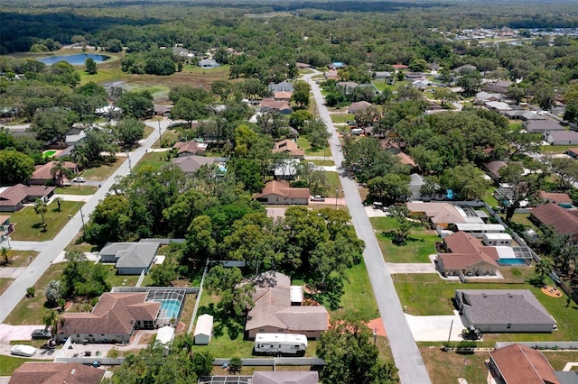 aerial view of residential area featuring a large body of water