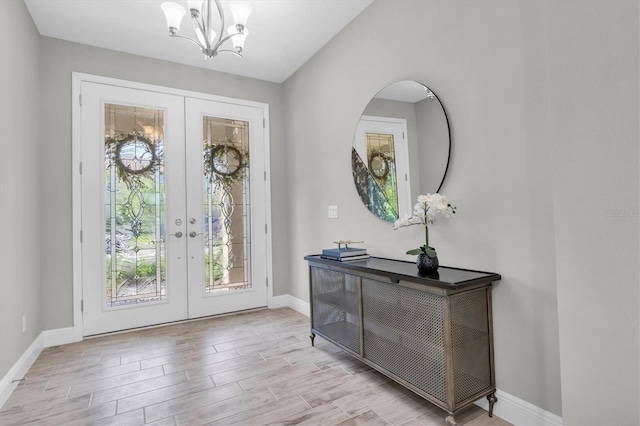 3767 Dragonfly Trl, Odessa, FL 33556 - entryway featuring french doors, baseboards, wood finished floors, and a chandelier