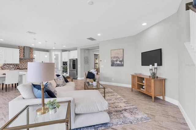 3767 Dragonfly Trl, Odessa, FL 33556 - living room featuring recessed lighting, baseboards, light wood finished floors, and stairs