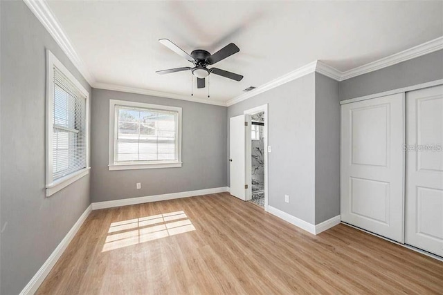 6989 300 Th Ave N, Clearwater, FL 33761 - unfurnished bedroom with light wood finished floors, baseboards, crown molding, a closet, and ceiling fan