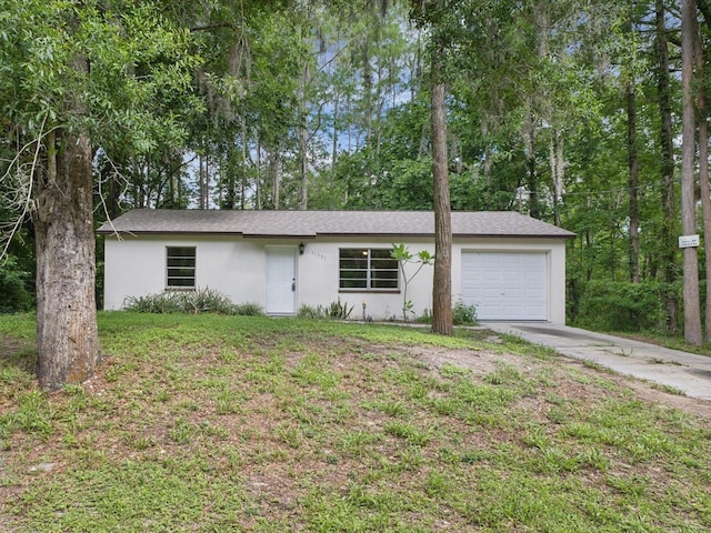 view of front of property with stucco siding, an attached garage, and concrete driveway