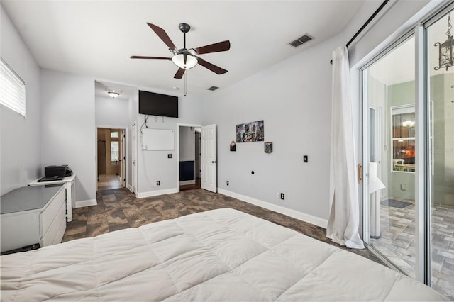 bedroom featuring ensuite bathroom, a ceiling fan, and baseboards