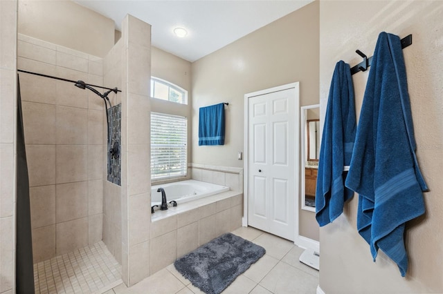 bathroom featuring tiled shower, a garden tub, and tile patterned flooring