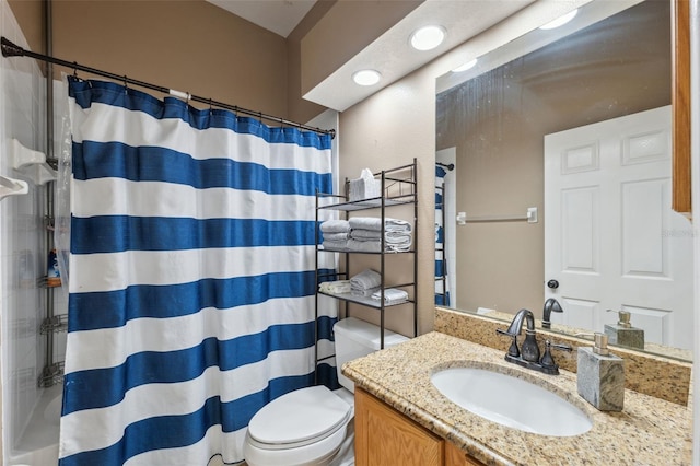 full bath featuring vanity, toilet, and curtained shower