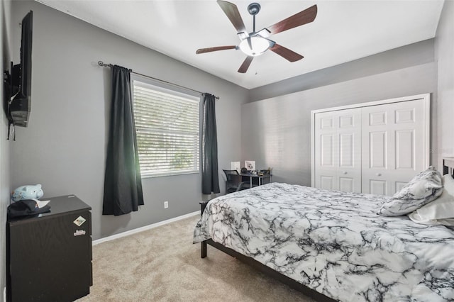 bedroom with carpet, a closet, baseboards, and ceiling fan