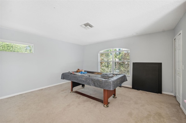 playroom featuring healthy amount of natural light, billiards table, and light carpet