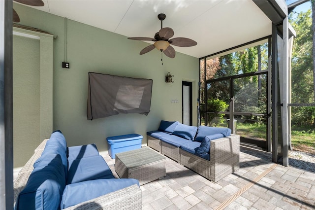 sunroom featuring a ceiling fan, outdoor lounge area, plenty of natural light, and vaulted ceiling