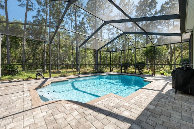 swimming pool with a patio area and a lanai