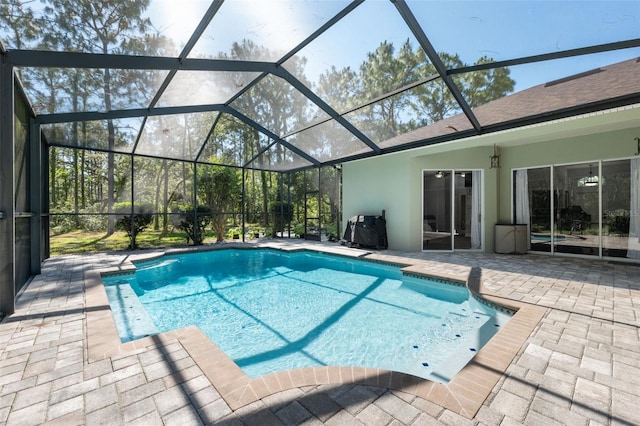 outdoor pool with a patio area and a lanai