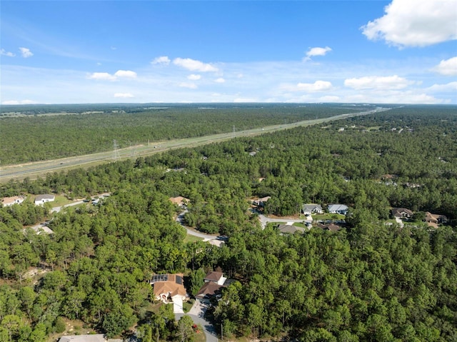 aerial overview of property's location with a heavily wooded area