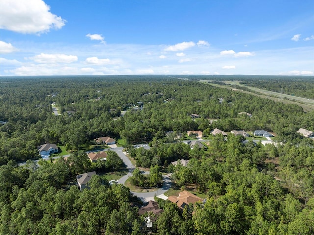 aerial overview of property's location featuring a heavily wooded area