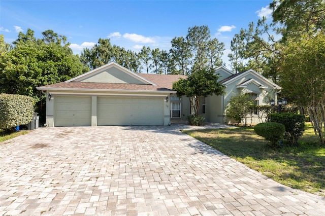 ranch-style home featuring decorative driveway, a garage, and stucco siding
