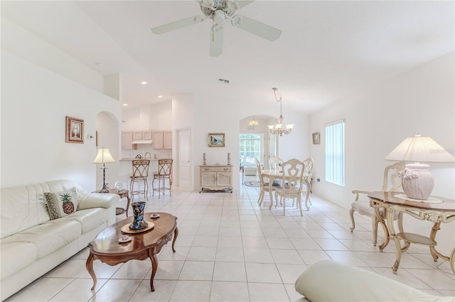 11158 Heathrow Ave, Spring Hill, FL 34609 - living room with a chandelier, vaulted ceiling, a ceiling fan, light tile patterned floors, and arched walkways