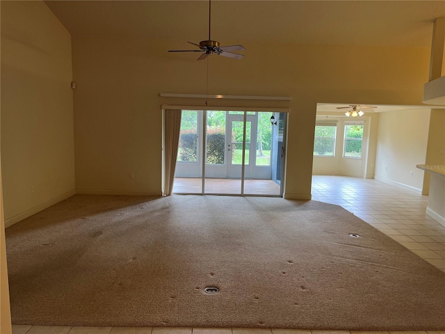 10054 Hernando Ridge Rd, Weeki Wachee, FL 34613 - carpeted spare room with a ceiling fan, tile patterned floors, baseboards, and a high ceiling