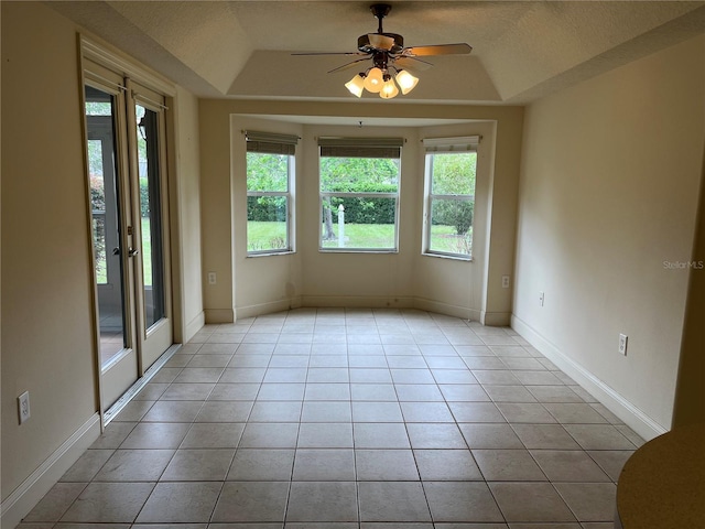 10054 Hernando Ridge Rd, Weeki Wachee, FL 34613 - spare room with plenty of natural light, a tray ceiling, light tile patterned floors, and a ceiling fan