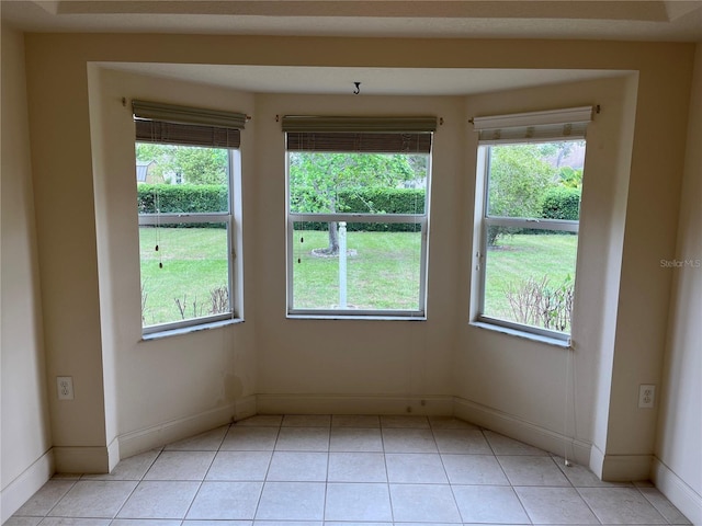 10054 Hernando Ridge Rd, Weeki Wachee, FL 34613 - unfurnished room featuring light tile patterned floors, baseboards, and plenty of natural light