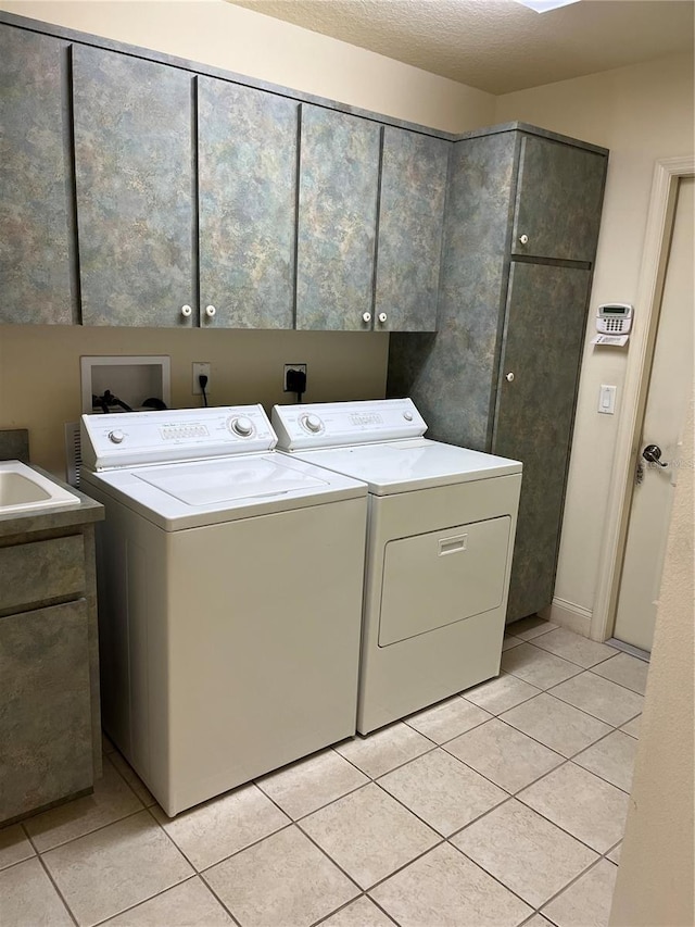 10054 Hernando Ridge Rd, Weeki Wachee, FL 34613 - washroom featuring cabinet space, washing machine and clothes dryer, and light tile patterned floors