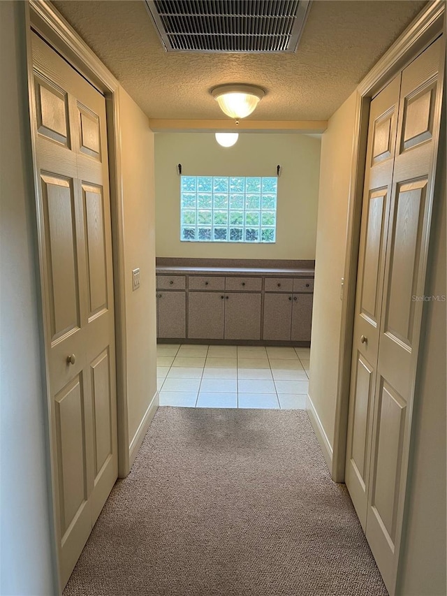 10054 Hernando Ridge Rd, Weeki Wachee, FL 34613 - hall with light colored carpet, baseboards, light tile patterned floors, and a textured ceiling