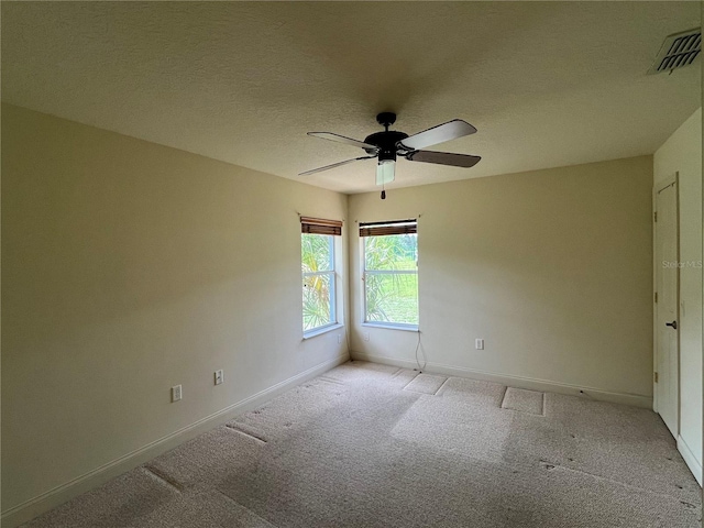 10054 Hernando Ridge Rd, Weeki Wachee, FL 34613 - spare room featuring baseboards, light colored carpet, a ceiling fan, and a textured ceiling
