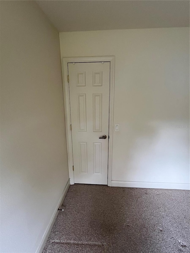 10054 Hernando Ridge Rd, Weeki Wachee, FL 34613 - empty room featuring carpet flooring and baseboards