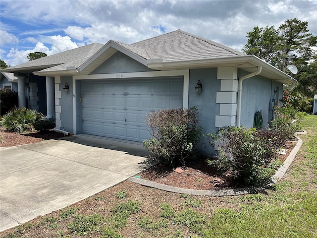 10054 Hernando Ridge Rd, Weeki Wachee, FL 34613 - view of side of home with an attached garage and driveway