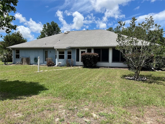 10054 Hernando Ridge Rd, Weeki Wachee, FL 34613 - rear view of house with a yard and stucco siding