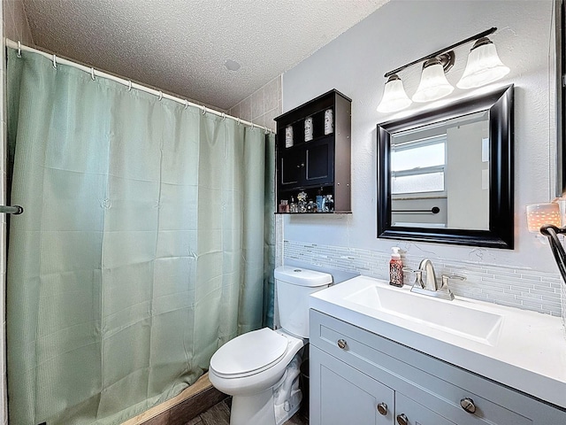 bathroom featuring a textured ceiling, toilet, vanity, a shower with shower curtain, and backsplash