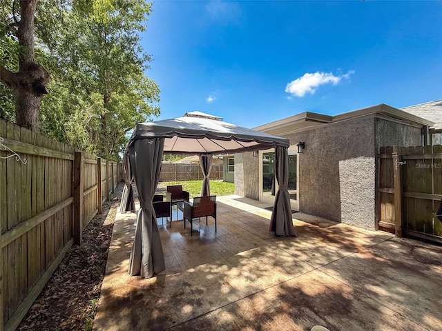 view of patio / terrace with a gazebo and a fenced backyard