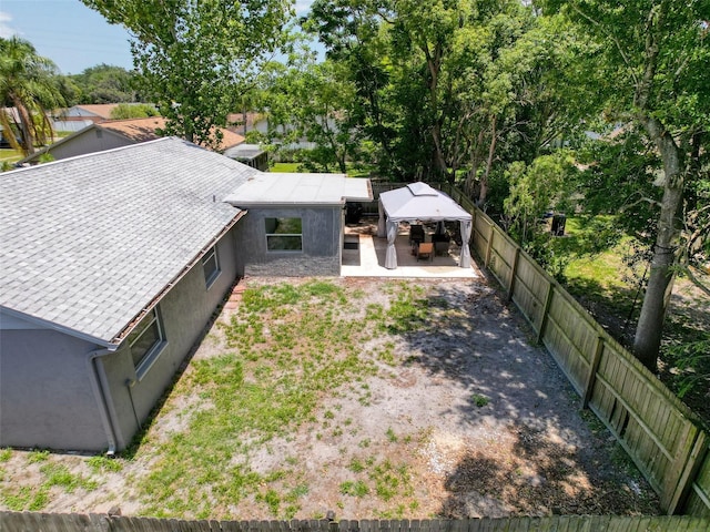 back of house with a fenced backyard, stucco siding, and a patio