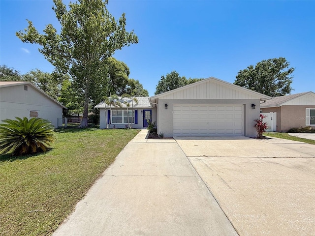 view of front facade with concrete driveway, a front yard, and an attached garage