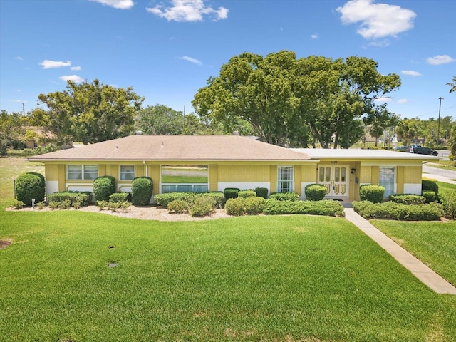 6823 Oak Hill Dr, New Port Richey, FL 34653 - ranch-style home with french doors, a front lawn, and stucco siding
