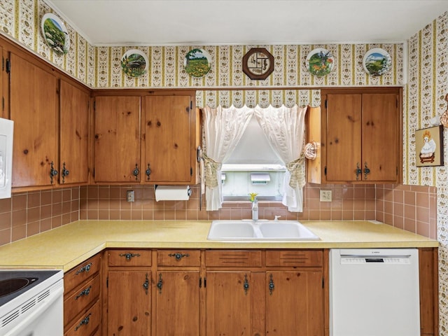 6823 Oak Hill Dr, New Port Richey, FL 34653 - kitchen with white appliances, a sink, light countertops, backsplash, and wallpapered walls