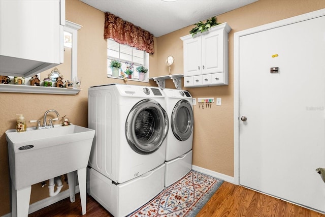 8596 SW 108th Place Rd, Ocala, FL 34481 - laundry room featuring washer and dryer, cabinet space, light wood-type flooring, and baseboards