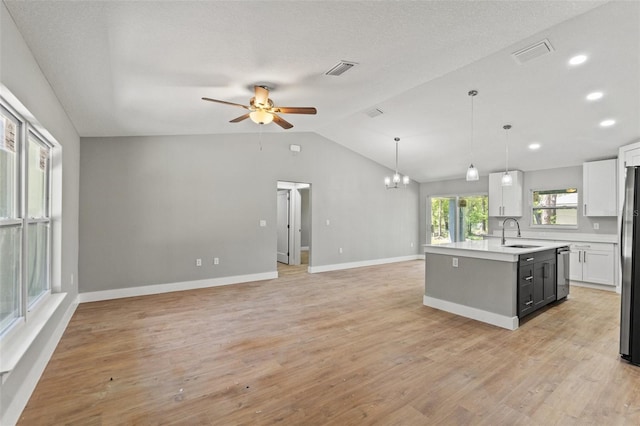 8792 N Sandree Dr, Dunnellon, FL 34434 - kitchen with a sink, light countertops, open floor plan, a ceiling fan, and an island with sink