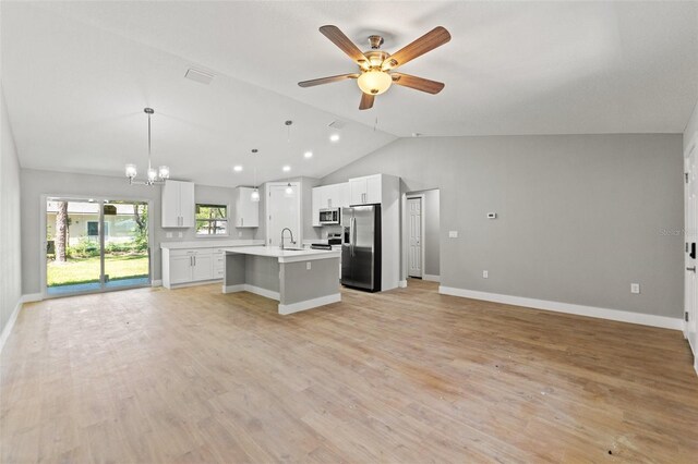 8792 N Sandree Dr, Dunnellon, FL 34434 - kitchen featuring stainless steel appliances, open floor plan, a sink, lofted ceiling, and light countertops