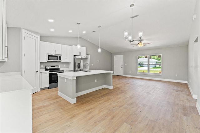 8792 N Sandree Dr, Dunnellon, FL 34434 - kitchen with appliances with stainless steel finishes, a sink, white cabinets, vaulted ceiling, and a chandelier