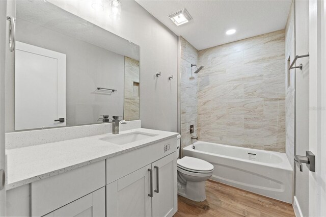 8792 N Sandree Dr, Dunnellon, FL 34434 - bathroom featuring wood finished floors, toilet,  shower combination, vanity, and recessed lighting