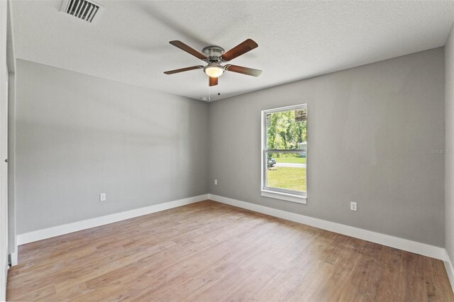 8792 N Sandree Dr, Dunnellon, FL 34434 - spare room with light wood-style flooring, ceiling fan, baseboards, and a textured ceiling
