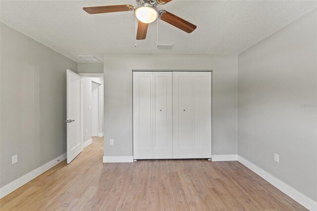 8792 N Sandree Dr, Dunnellon, FL 34434 - unfurnished bedroom featuring light wood-type flooring, baseboards, a closet, and ceiling fan