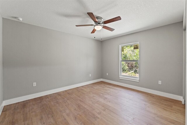 8792 N Sandree Dr, Dunnellon, FL 34434 - empty room with ceiling fan, light wood-type flooring, baseboards, a textured ceiling, and a smoke detector