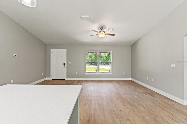8792 N Sandree Dr, Dunnellon, FL 34434 - unfurnished living room with ceiling fan, baseboards, and light wood-type flooring