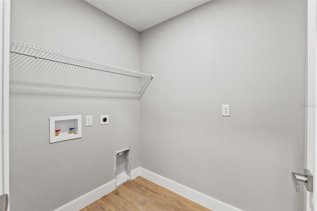 8792 N Sandree Dr, Dunnellon, FL 34434 - laundry area featuring electric dryer hookup, hookup for a washing machine, baseboards, and light wood-style floors