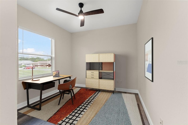 home office featuring a ceiling fan, baseboards, and wood finished floors